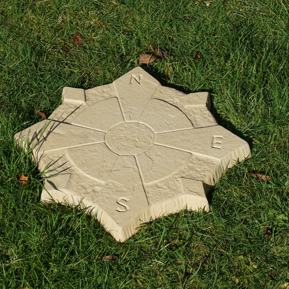 Compass Stepping Stone 440mm Buff on grass